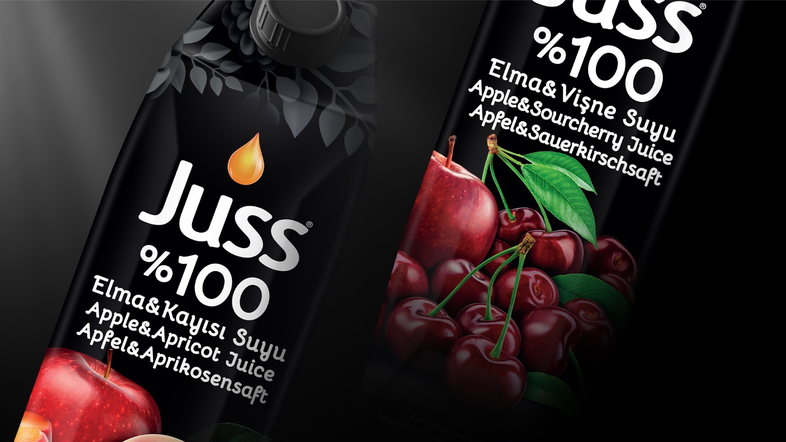 JUSS juice cartons — black pack with fruit rendering